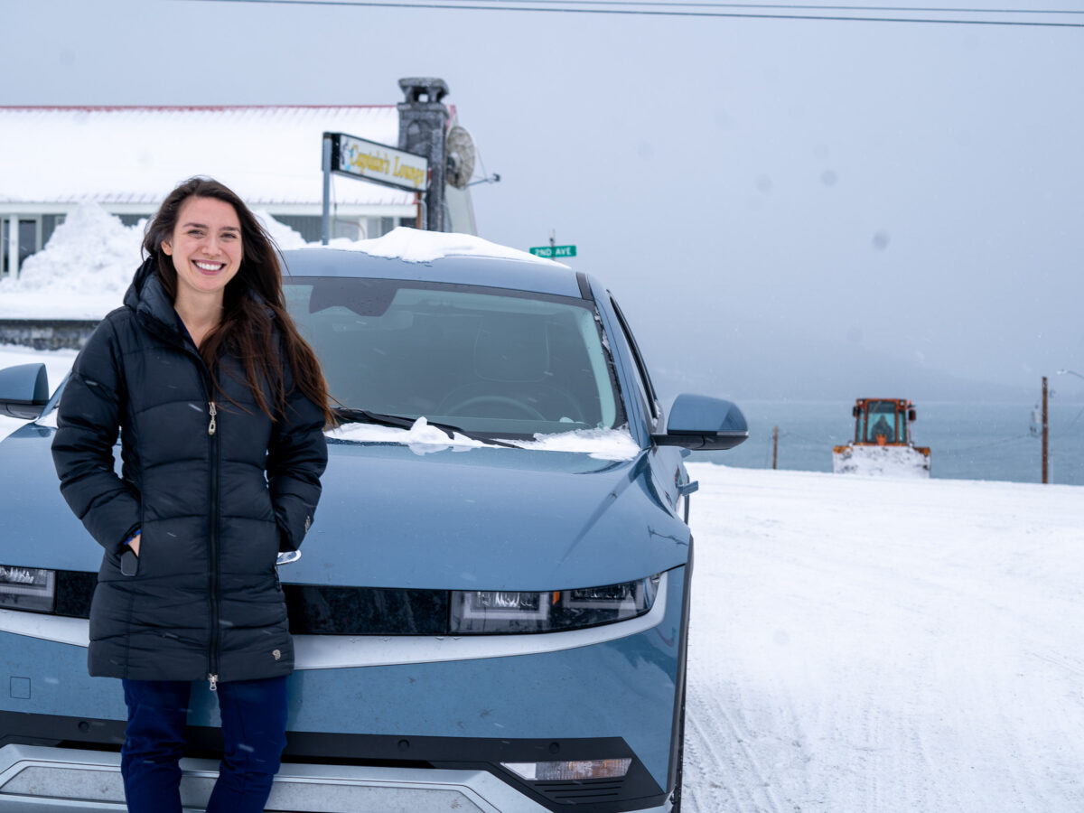 EV owner Hannah Reeves with her Hyundai Ionic. Despite some glitches, Reeves said she doesn't think she'll buy a gas vehicle again. (Photo by Lex Treinen/Chilkat Valley News)