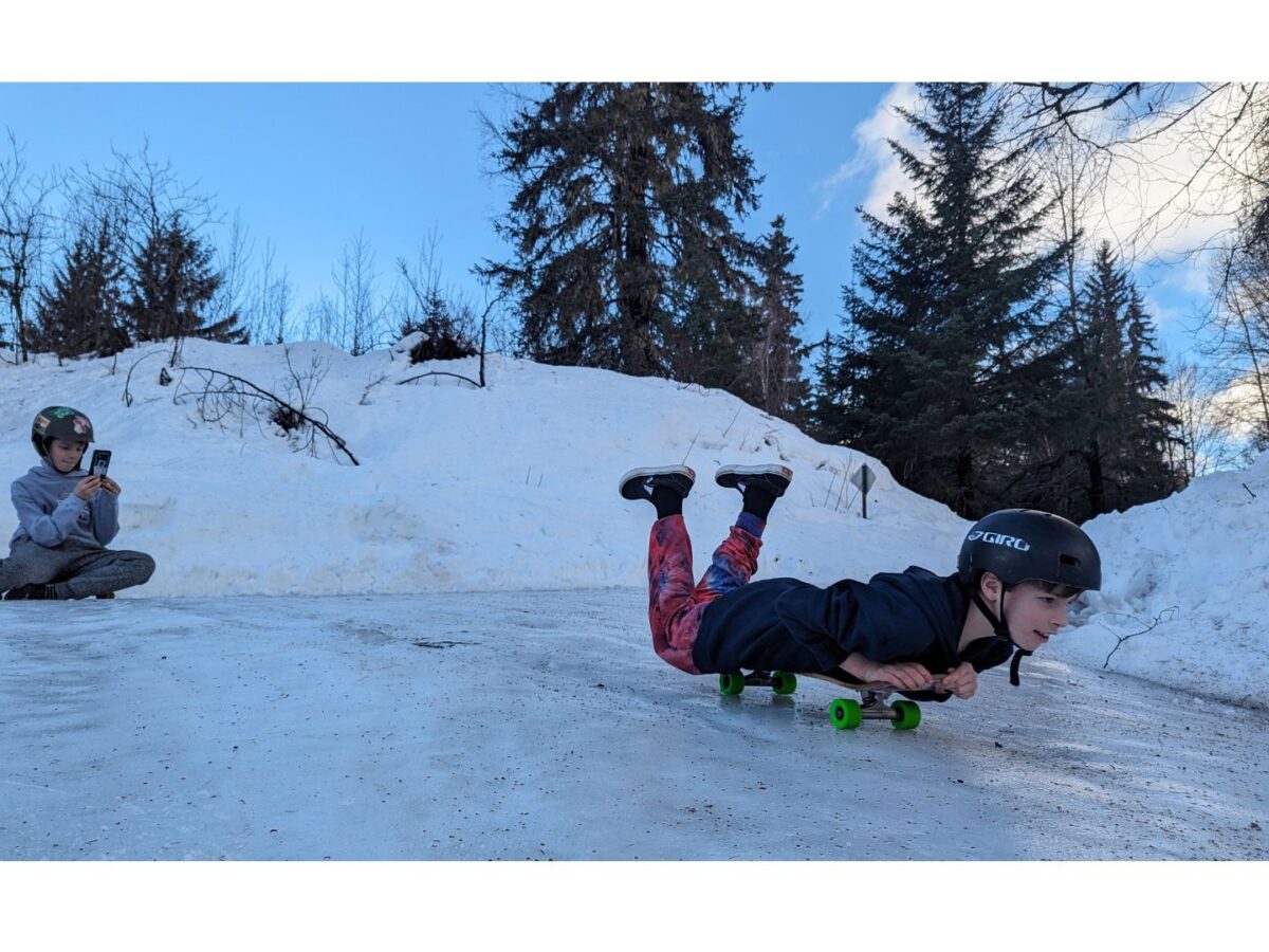 Jayson and and Elijah Pawlison skate board down their icy driveway pm Eagle Bluff Drive on Tuesday. 10-year-old Jayson said they had plenty of wipeouts, but the media attention helped him stay focused and make it down the hill without falling. Klukwan school and Haines bus service to the upper valley were cancelled Monday and Tuesday after an avalanche blocked the highway at Mile 21. More weather photos inside. (Lex Treinen/Chilkat Valley News)