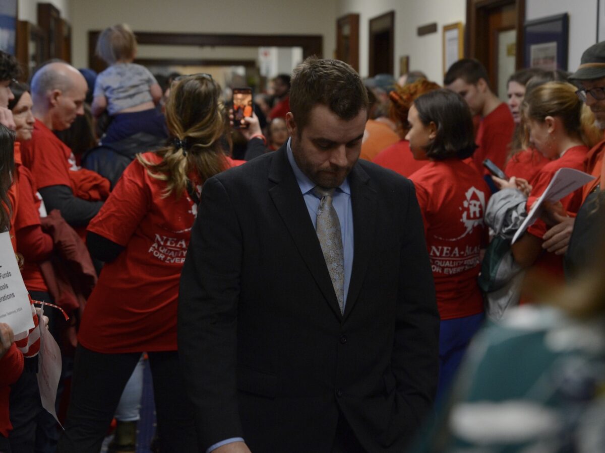 Rep. Jesse Sumner, R-Wasilla, looks down as he enters the House chambers before a veto override vote on Senate Bill 140 on Monday, March 18, 2024. Sumner voted yes on the override, which failed by a single vote. (Photo by James Brooks/Alaska Beacon)