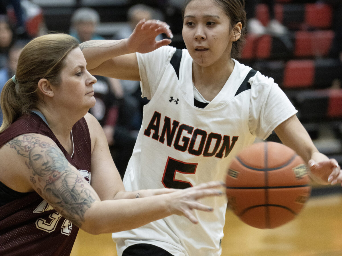 3-17-24: Haines player Alissa Beske passes while being guarded by Angoon's Cheyenne Kookesh during the fiirst day of the 75 Annual Lion's Club Gold medal turnament at George Houston Gym at JUNEAU-DOUGLAS HIGH SCHOOL: YADAA.AT KALÉ. (Photo by: Brian Wallace/ for the Chilkat Valley News)