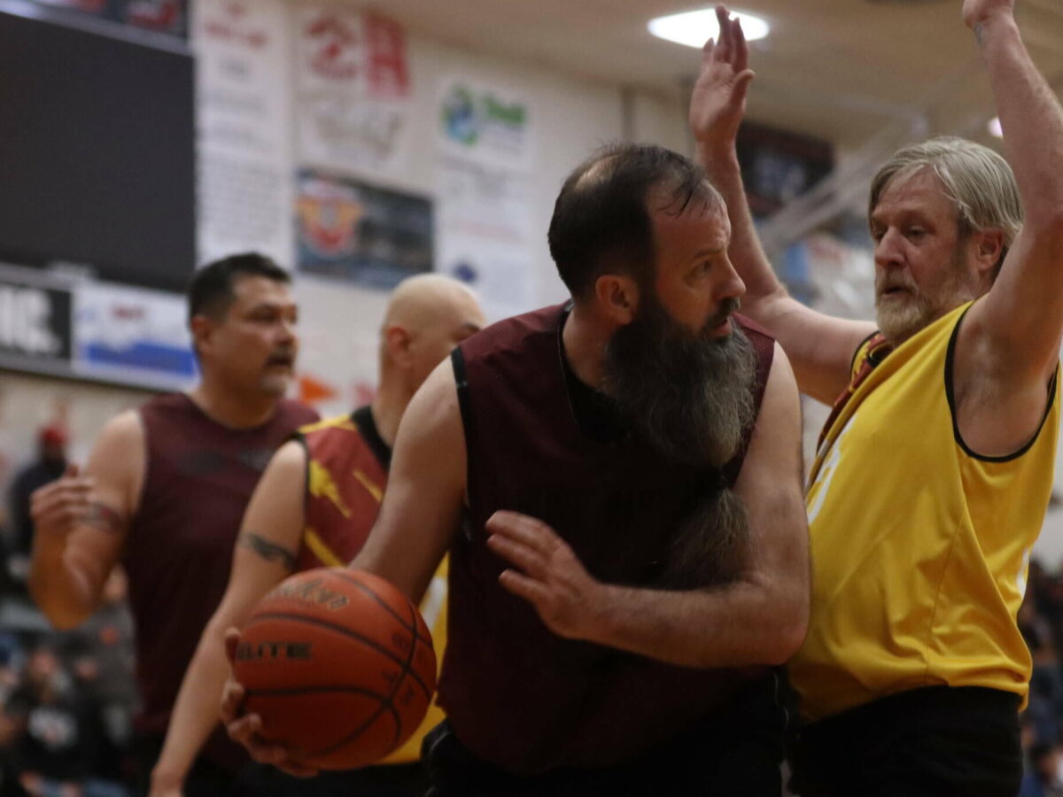 Hoonah’s Mark Prpich (22) drives the lane against Juneau’s Doug Draowski (5) on Saturday during last year’s Gold Medal championship game for M bracket at Juneau-Douglas High School: Yadaa.at Kalé on March 25, 2023. Prpich finished the game with 10 points. (Ben Hohenstatt / Juneau Empire)
