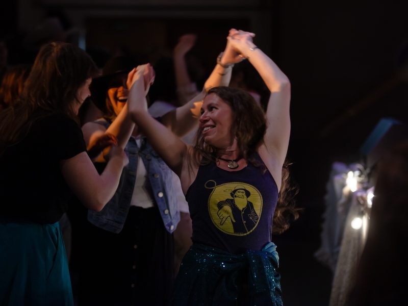 Dancers take over the floor in front of the stage on Saturday, May 18, 2024, at the Chilkat Center in Haines, Alaska. The Juneau-based Muskeg Collective played a "Cowboy Ball" as a fundraiser for KHNS. (Rashah McChesney/Chilkat Valley News)