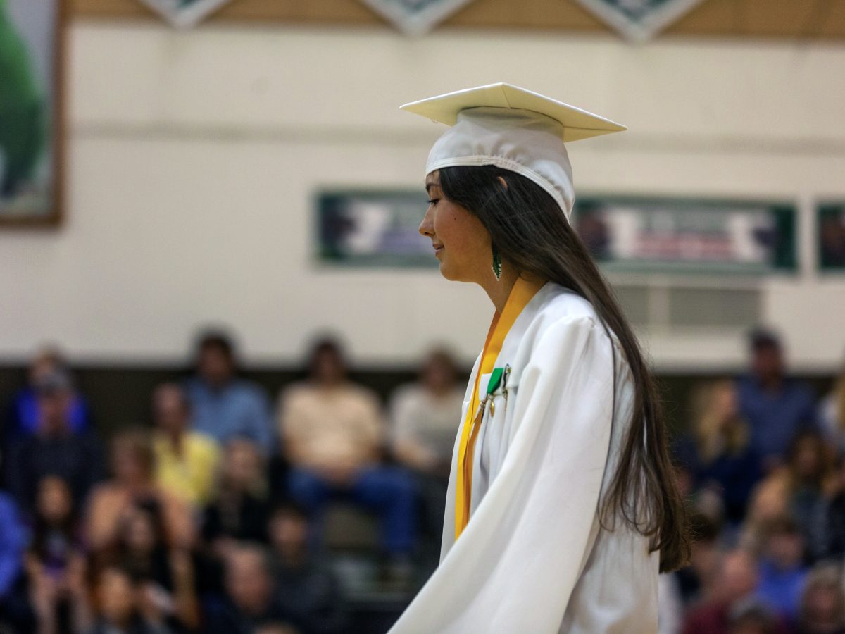 Salutatorian Raven Hotch makes her way to the podium to deliver a speech during her senior graduation ceremony on Tuesday, May 21, 2024, in Haines, Alaska. (Rashah McChesney/Chilkat Valley News)