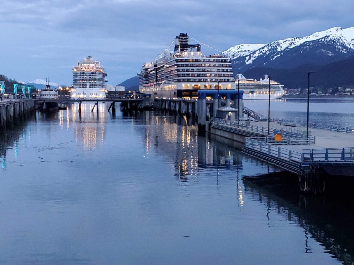 Three cruise ships are docked along Juneau’s waterfront on the evening on March 10, as a Princess cruise ship on the right is departing the capital city. (Photo by Yereth Rosen/Alaska Beacon)
