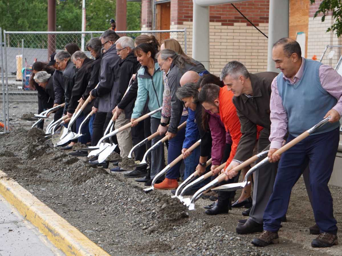 Alaska Native Tribal Health Consortium officials, state lawmakers and the director of the Indian Health Service dig into dirt on Wednesday at the Alaska Native Medical Center in a ceremonial groundbreaking for the hospital's $257 million emergency department expansion. (Photo by Yereth Rosen/Alaska Beacon)