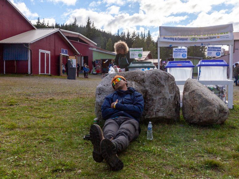 A young man sleeps on a rock in the sun at the Southeast Alaska State Fair grounds in Haines. Meant to show the relaxation of the day.