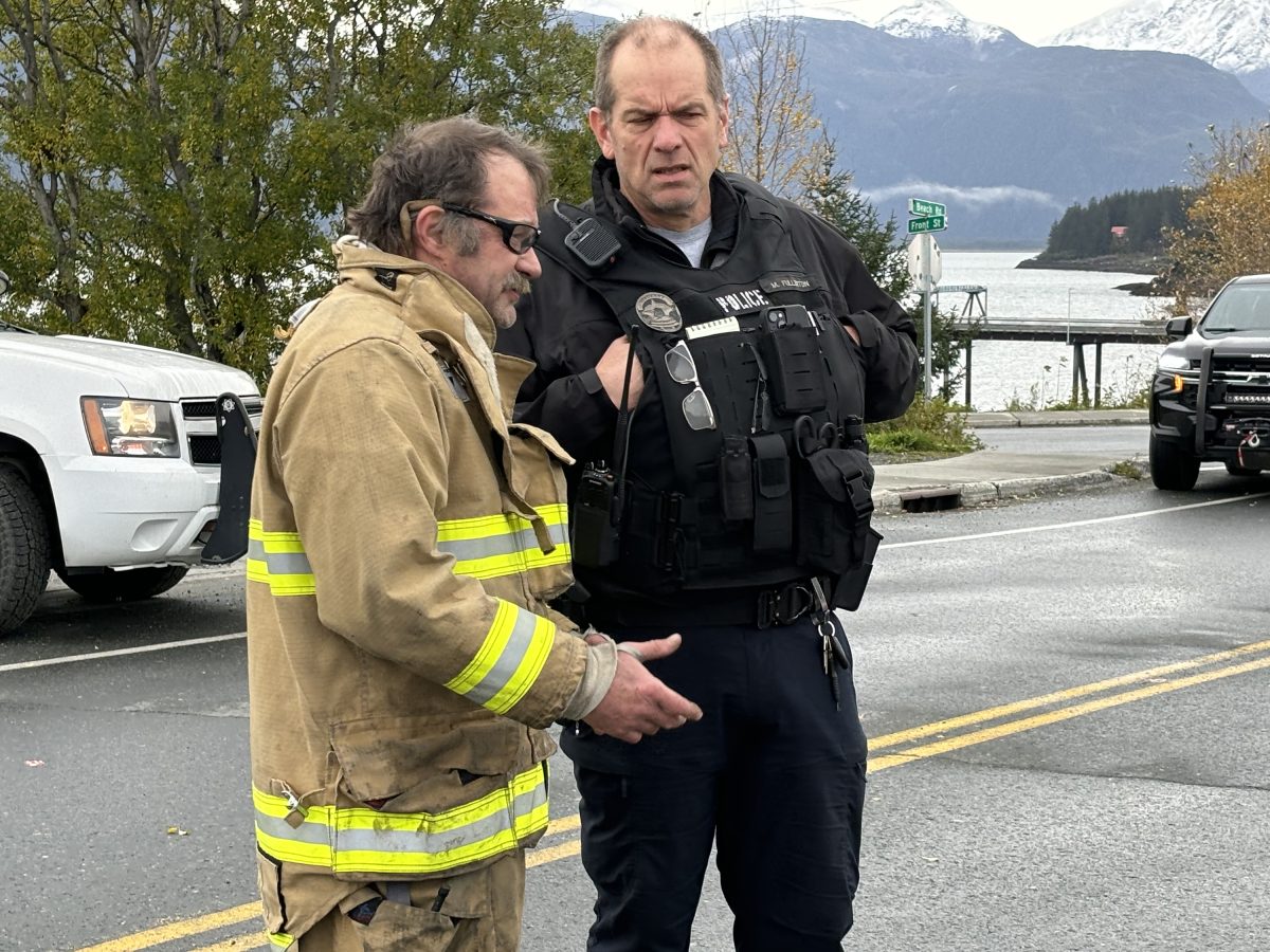 (Courtesy/Matt Davis) Fire Chief Brian Clay talks with Haines police officer Michael Fullerton the morning after a fire destroyed several apartments and businesses housed in a building at the corner of the Haines Highway and Front Street on Oct. 6, 2024, in Haines, Alaska.
