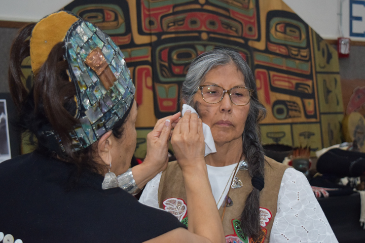 Tears, represented as black paint, are traditionally wiped clean after a mourning ceremony, on Oct. 26, 2024, in Angoon, Alaska where the Navy apologized for bombarding the village more than a century ago. (Francisco Martínezcuello/Chilkat Valley News)