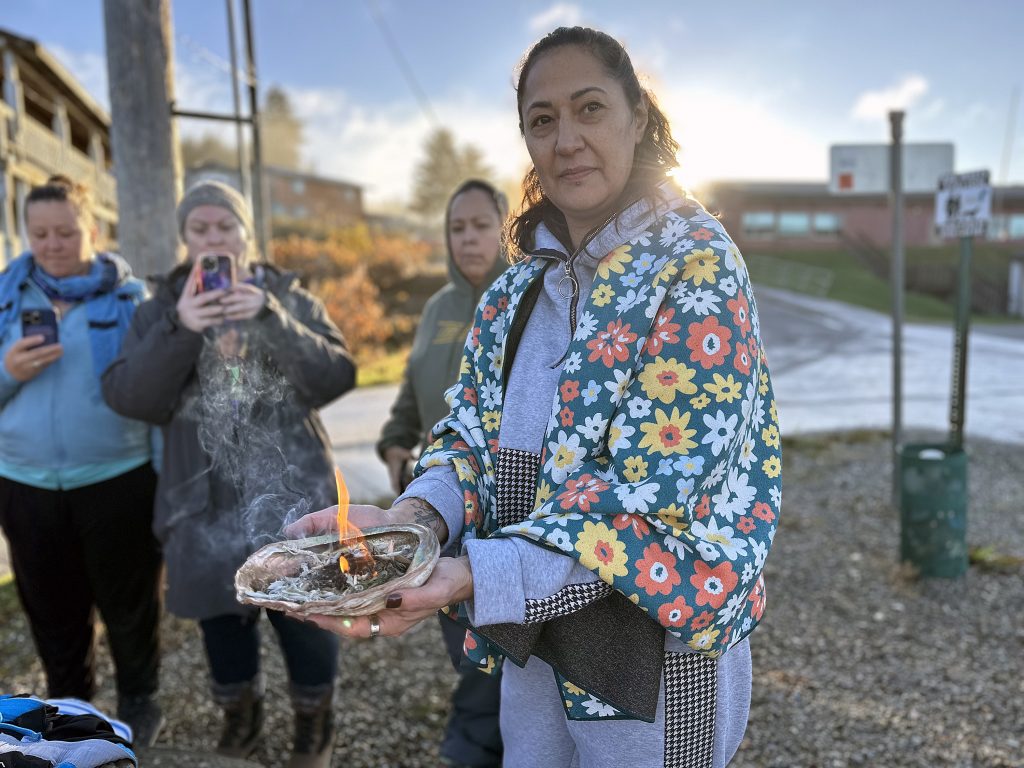 Jamiann S’eiltin Hasselquist lead nine women through a ceremony the day after the U.S. Navy apologized for unjustly bombarding the community of Angoon more than 140 years ago on Oct. 27, 2024, in Haines, Alaska. (Francisco Martínezcuello/Chilkat Valley News)