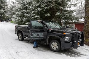 Interim police chief Michael Fullerton takes off some of his gear after responding to reports of a violent altercation and shots fired in a neighborhood off of Fourth Avenue on Monday, Dec. 9, 2024, in Haines, Alaska.