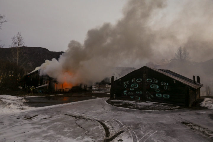 Firefighters working to contain a blaze at the Old Field Kitchen prioritized keeping two fuel tanks and a nearby replica of a tribal house on Saturday, Dec. 7, 2024, in Haines, Alaska.