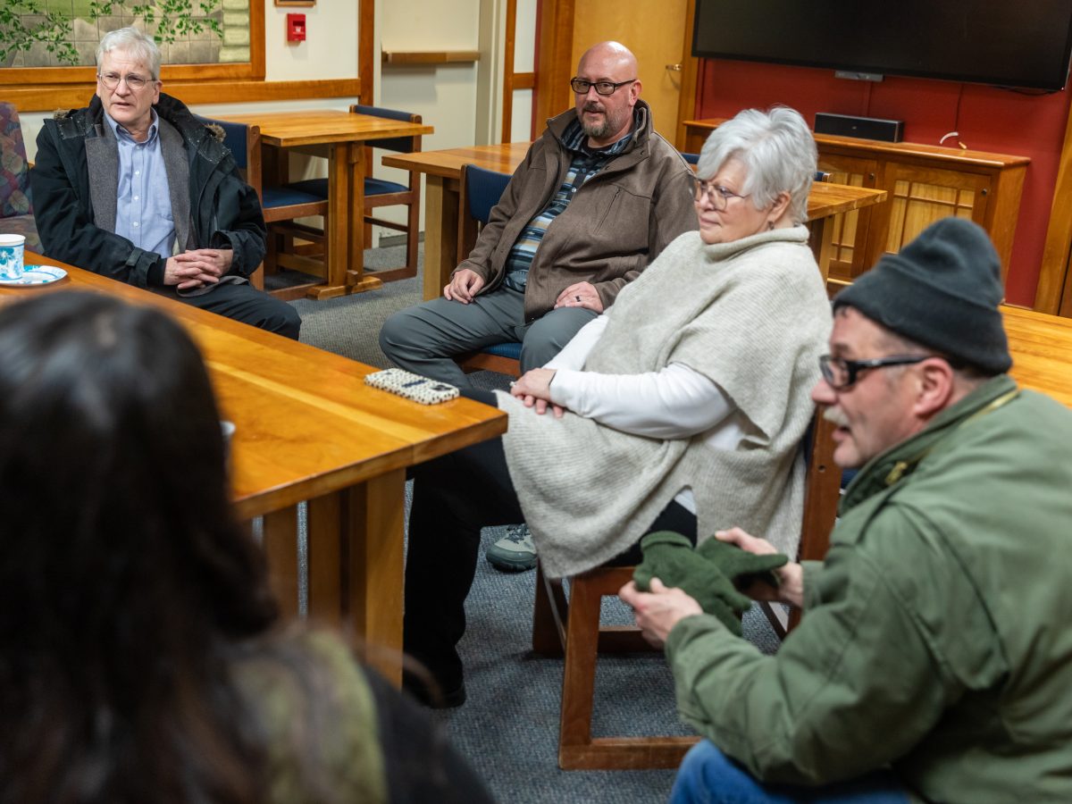 (left) Mayor Tom Morphet, police chief candidate Gregory Boris and others gather in the library for a meet-and-greet on Monday, Jan. 20, 2025, in Haines, Alaska. (Rashah McChesney/Chilkat Valley News)