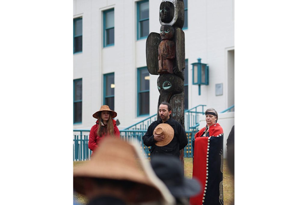 (left) Esther Aaltséen Reese stands beside Mike Aak'wtaatseen Hoyt and Katherine George-Byrd outside the Wrangell Post Office on Saturday, Jan. 11, 2025, in Wrangell, Alaska. It was the final stop on the walking tour before the Army's apology for its 1869 bombardment of the Native village. The post office now stands where the U.S. Army fort was once located. (Courtesy/Sam Pausman,Wrangell Sentinel)
