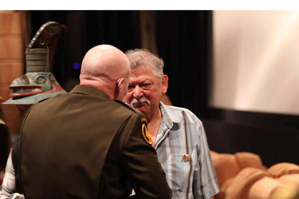 Wrangell Cooperative Association President Ed Rilatos speaks with Ma. Gen. Joseph Hillbert, commander of the U.S Army 11th Airborne Division. The two spoke shortly after the general delivered a historic apology on Jan. 11 for the Army's 1869 bombardment of Wrangell's Tlingit village. (Courtesy/Sam Pausman, Wrangell Sentinel)