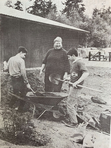 July 11, 1996. Jeremiah Brower, right, and Peter Klein plant shrubs at the fairgrounds while fair manager Joanne Waterman looks on. 